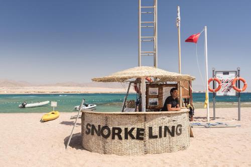 a man sitting in a lifeguard stand on the beach at Barceló Tiran Sharm in Sharm El Sheikh