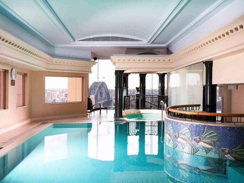 a swimming pool in the middle of a building at The Sebel Quay West Suites Sydney in Sydney