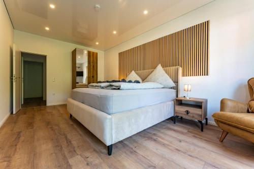 a bedroom with a bed and a couch and a chair at Moselresidenz Bellevue Alf in Alf