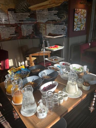 a table with many different types of food on it at Anchor Inn by Greene King Inns in Beer