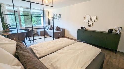 a living room with a couch and a mirror at Kampenwand am Chiemsee in Prien am Chiemsee