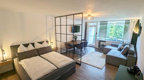 a bedroom with a bed and a living room at Kampenwand am Chiemsee in Prien am Chiemsee