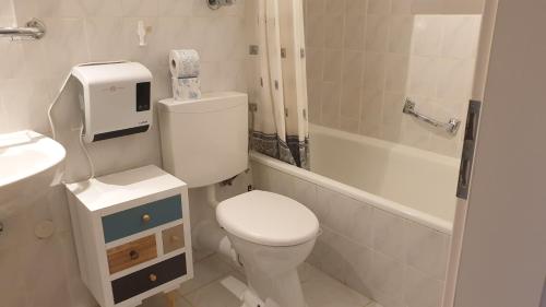 a white bathroom with a toilet and a sink at Apartment mit 2 Zimmer im Bayerischen Wald in Sankt Englmar