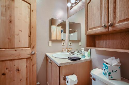 a bathroom with a sink and a toilet and a mirror at Blazing Saddles #122 in Breckenridge