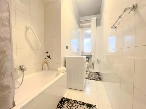 トリノにあるTrilocale con parcheggio privato Arena Inalpi, PalaTazzoli, Palavela Lingotto, "Exclusive Suite " La casa di Bertino "の浴槽とシャワー付きの白いバスルーム