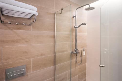 baño con ducha y puerta de cristal en B&B HOTEL Lleida, en Lleida