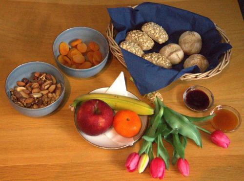 a table with bowls of fruits and vegetables and nuts at HarTeluk Joure in Joure