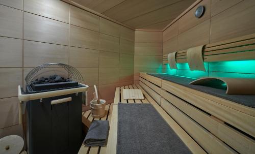 a room with a sauna with benches and blue lights at Hotel Weisses Roessl in Kitzbühel