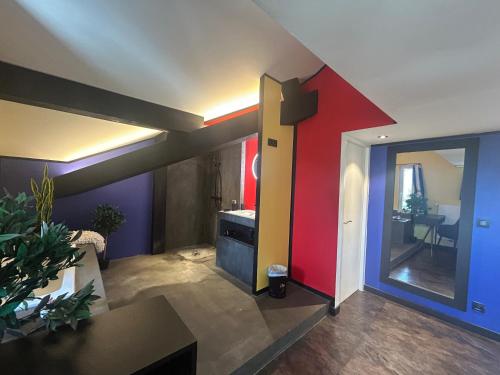 a living room with a red and blue wall at Bel Air - Propriétés Mont Amour in Montriond