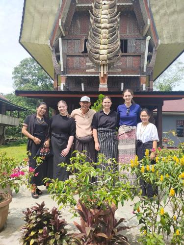 a group of people standing in front of a building at Toraja Homestay & Coffee Bunna in Rantepao
