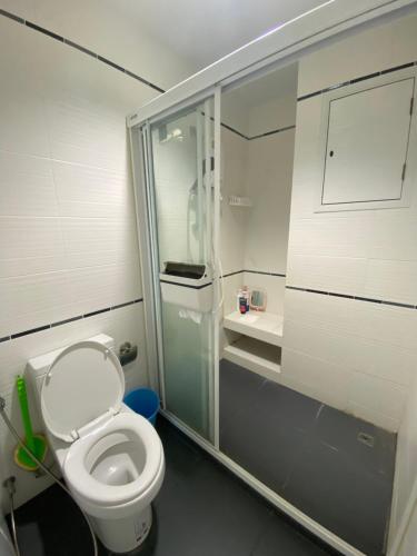 a bathroom with a toilet and a glass shower at centric sea pattaya中心海 in Pattaya