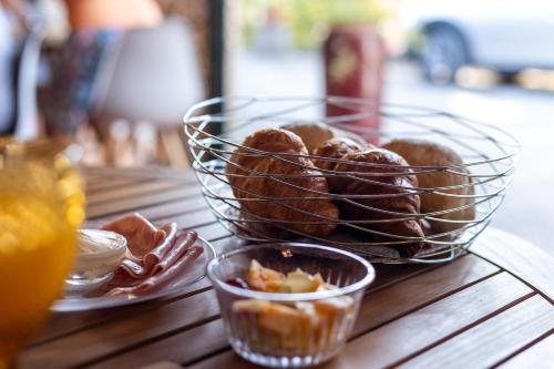 a basket of pastries on a table with a drink at Casa do Vale in Sao Pedro de Tomar