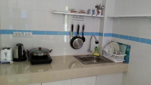 a kitchen with a sink and a counter top at Vipha Ville Resort in Ban Huai Yang