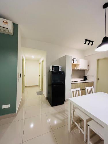a kitchen and dining room with a white table and chairs at COMFY SKY SUITE Free Wifi & Netflix in Kajang