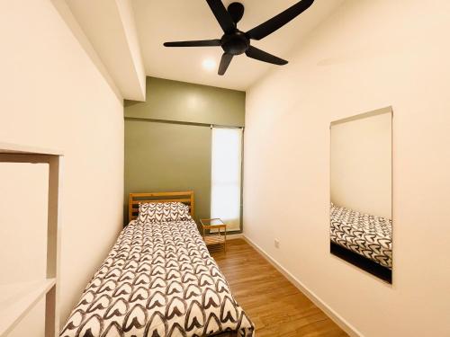 a bedroom with a bed and a ceiling fan at COMFY SKY SUITE Free Wifi & Netflix in Kajang