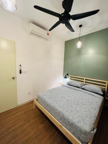 a bedroom with a bed and a ceiling fan at COMFY SKY SUITE Free Wifi & Netflix in Kajang