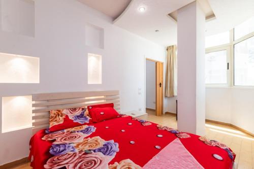a bedroom with a large red bed with red pillows at Hurghada Makramia compound in Hurghada