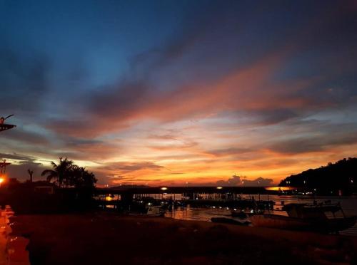 a sunset over a marina with boats in the water at Homestay Kuala Dungun in Dungun