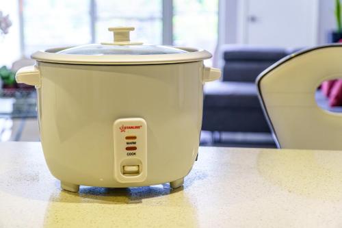 a slow cooker sitting on top of a table at Luxury Apartment at 20 South suite 108 in Kingston
