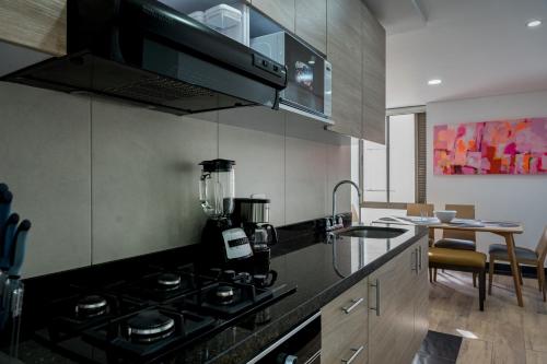 a kitchen with a stove and a counter top at FASCINANTE ALOJAMIENTO in Bogotá