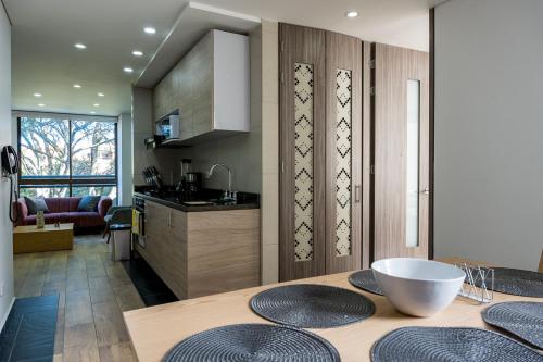a kitchen with a table with four plates on it at FASCINANTE ALOJAMIENTO in Bogotá