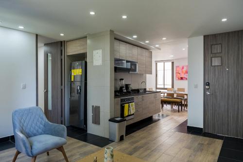 a kitchen with a refrigerator and a dining room at FASCINANTE ALOJAMIENTO in Bogotá