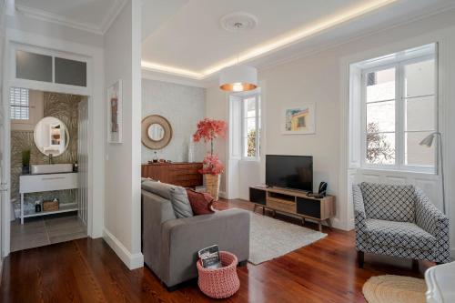 a living room with a couch and a television at Villa Quebra Costas by An Island Apart in Funchal
