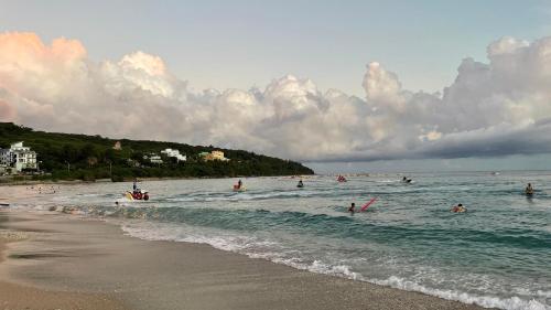 a group of people in the water at the beach at Kenting Southern Dream Resort in Kenting