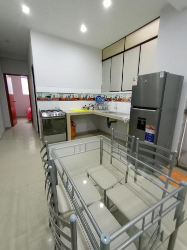 a kitchen with a table with chairs in it at O'CALA HOUSE in Huánuco