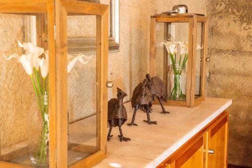 a shelf with two figurines of birds on it at Casa do Vale in Sao Pedro de Tomar