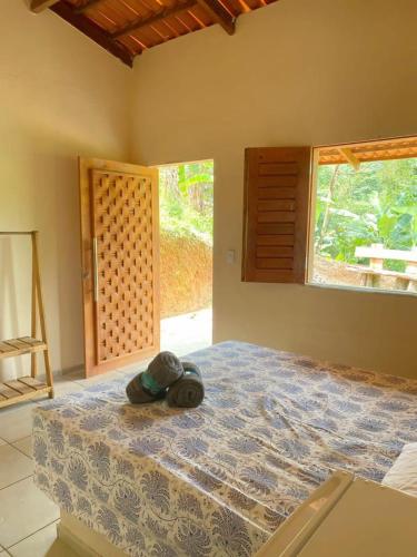 Tempat tidur dalam kamar di Chalé Sol