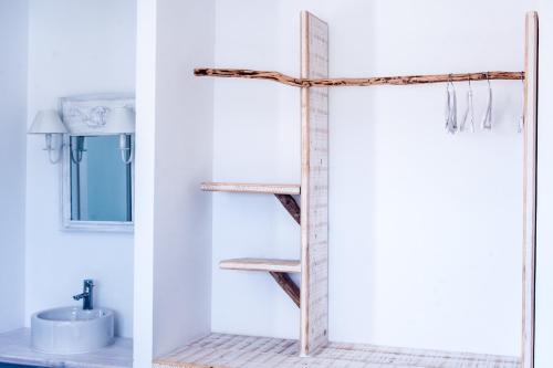 a bathroom with a wooden cross on the wall at Hostal Bon Sol in Sant Ferran de Ses Roques
