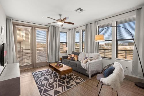 a living room with a couch and some windows at Modern Town Lake Waterfront CozySuites Paradise 07 in Tempe