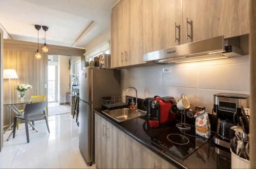 a kitchen with a sink and a counter top at Cozy Penthouse Suite w Balcony - Amazing Manila Bay View and City Skyline near MOA in Manila