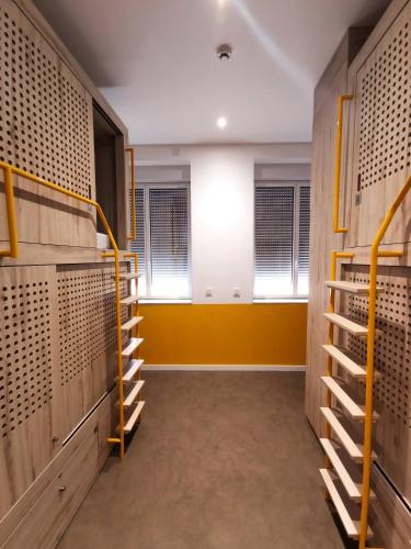 a dressing room with wooden racks and windows at Bloom Hostel Bar & Garden in Bordeaux