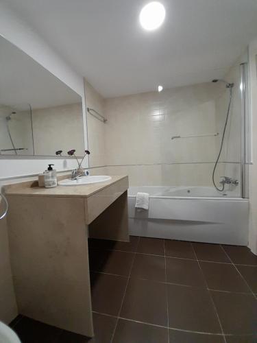 a bathroom with a sink and a bath tub at Feel The Vibe Alcaidesa in San Roque
