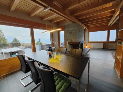 a kitchen and dining room with a table and chairs at Traumhafte Villa Seelisberg in Seelisberg