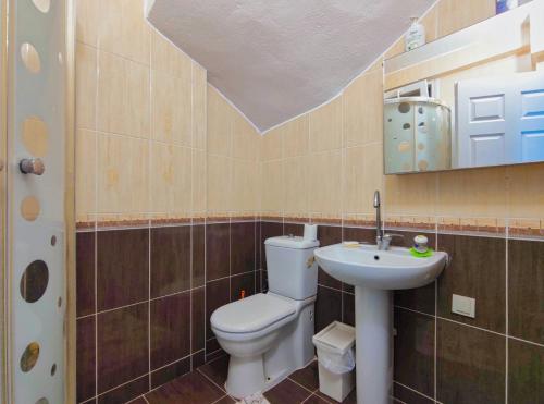 a bathroom with a toilet and a sink at enjoy the cesme in Çeşme