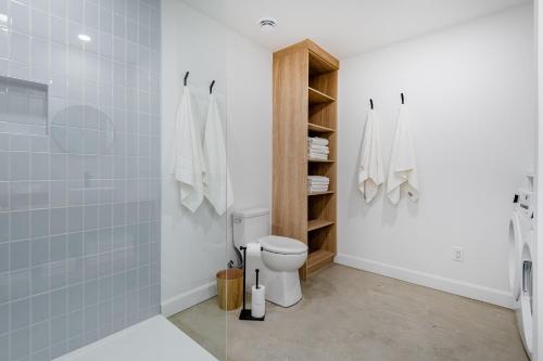 a bathroom with a toilet and a shower at SOFA VILLAS MONT SAINTE-ANNE in Beaupré