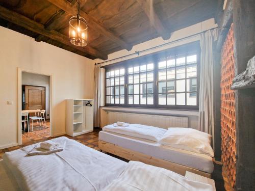 two beds in a room with a large window at Tolstov House - 6 Room House with Terrace and Parking - 30 Min Messe DUS in Mönchengladbach