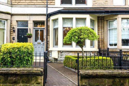 a house with a black gate in front of it at The Harrogate Townhouse in Harrogate