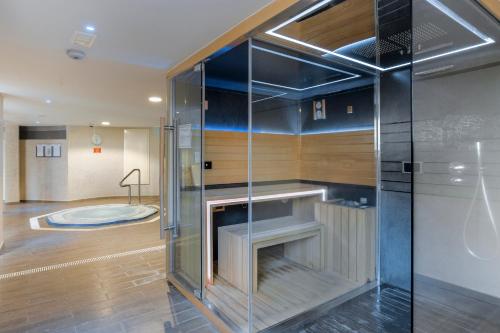 a glass shower in a bathroom with a tub at Santa Barbara Golf and Ocean Club in San Miguel de Abona