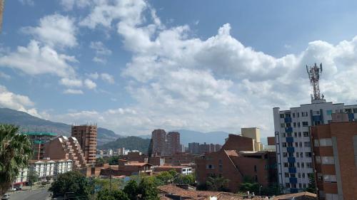 a view of a city with buildings and mountains at Penthouse-Loft, Laureles, Vistas a Medellín - 801 in Medellín