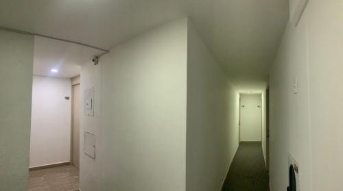 an empty hallway with white walls and white doors at Penthouse-Loft, Laureles, Vistas a Medellín - 801 in Medellín