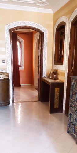 a room with an open door with a sink in it at maison d'hôtes Le petit jardin Marrakech in Marrakech