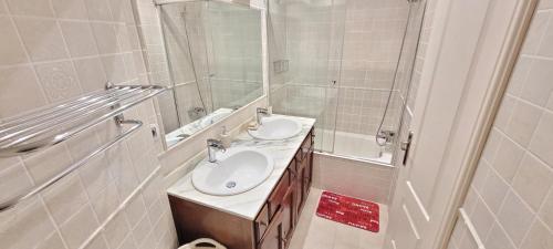 a white bathroom with a sink and a shower at Rest HOME in Getxo