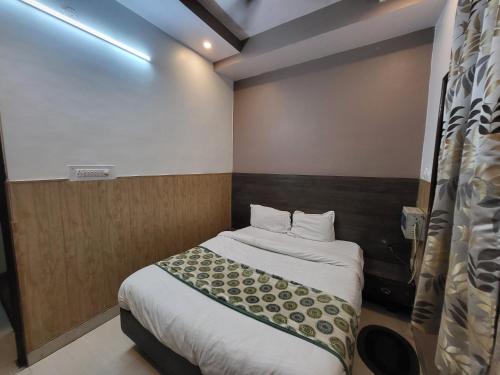a small bedroom with a bed in a room at Hotel Atithi Residency in Lucknow