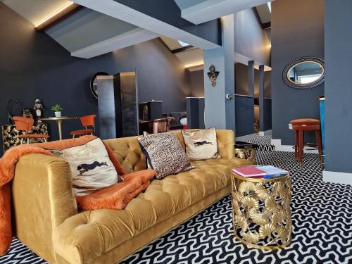 a living room with a brown couch and a table at The Studio in Preston