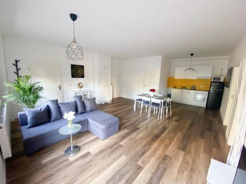 Hotel Zur Linde : غرفة معيشة مع أريكة زرقاء ومطبخ
