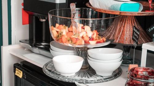 a bowl of fruit sitting on top of a coffee maker at Boutique Hotel Ferrara in Ferrara